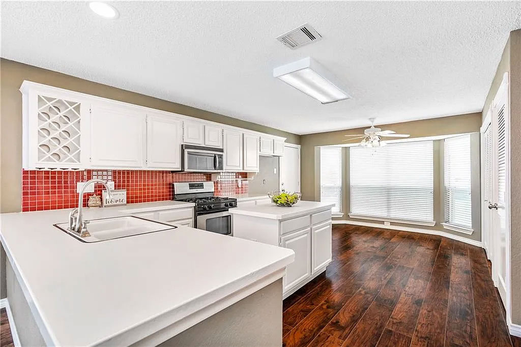 Kitchen before renovation — dated wood cabinets and layout