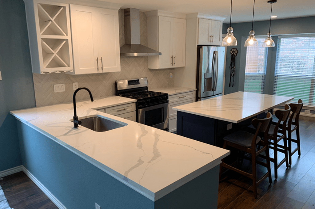 Kitchen after renovation — modern white kitchen with marble island
